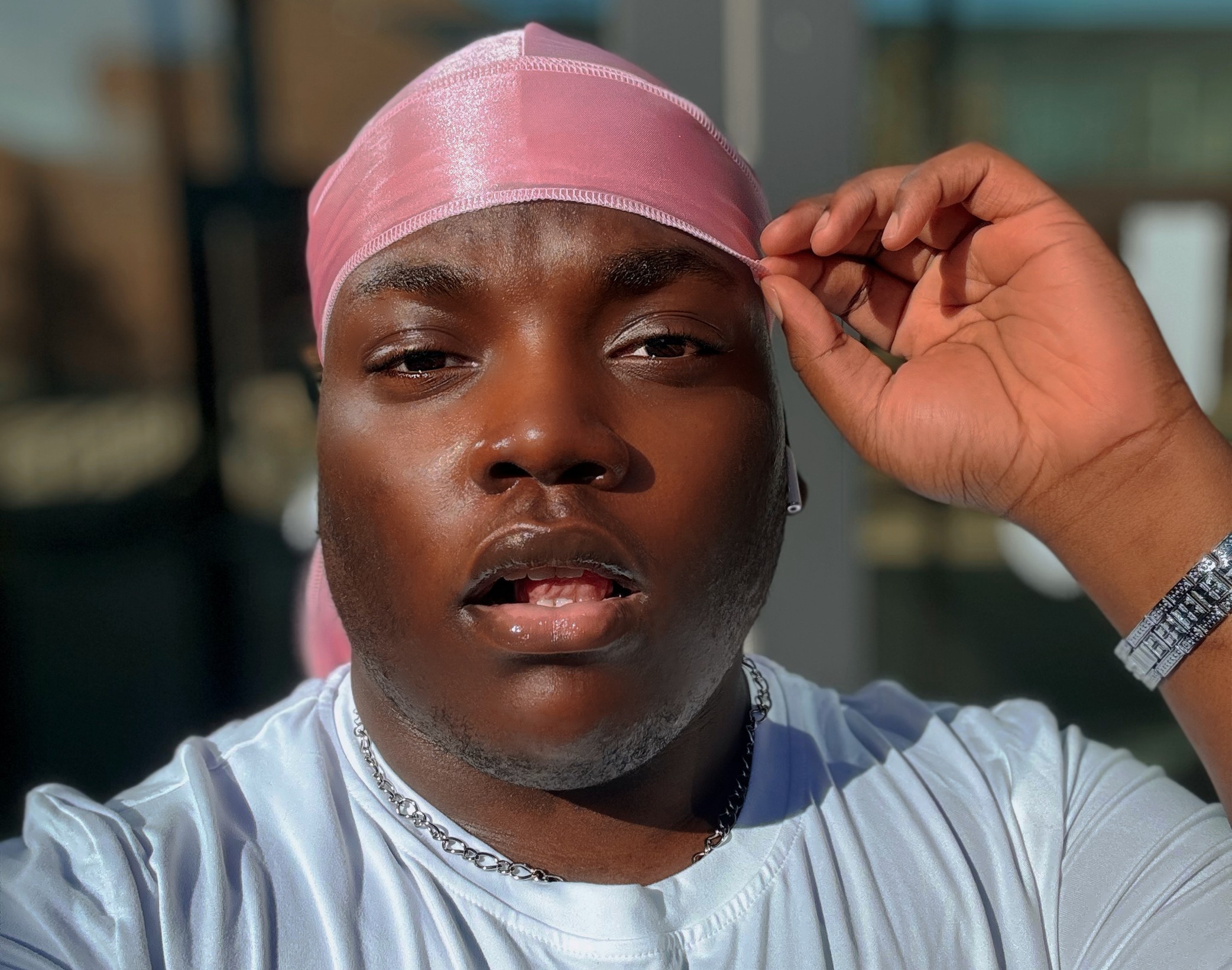 Selfie of London in a pink durag and a white T-shirt.